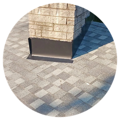A brick chimney is sitting on top of a brick patio.