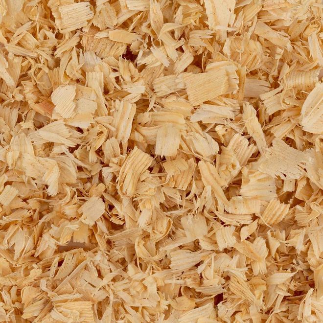 Close-up of light tan wood shavings filling the frame