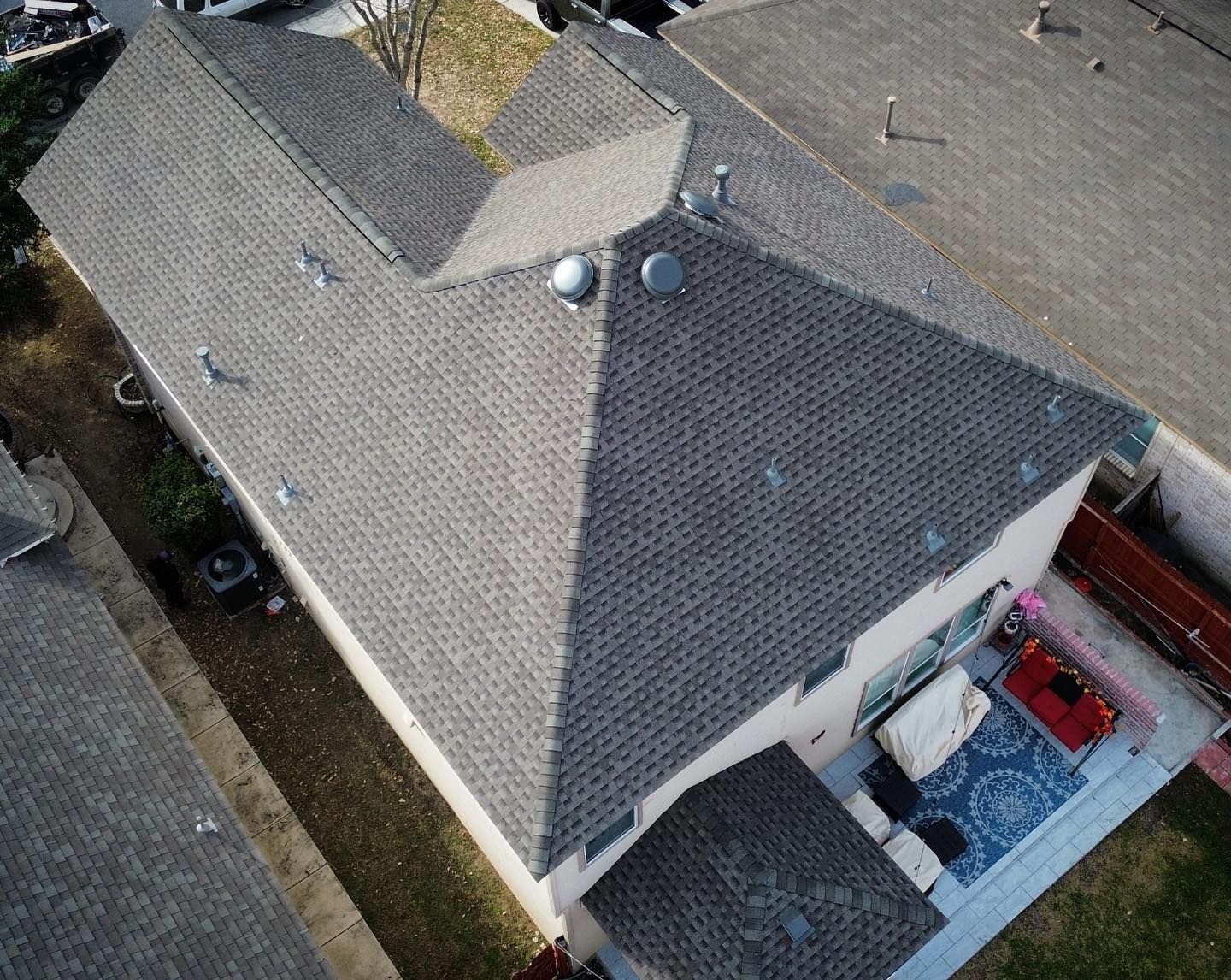 An aerial view of a house with a gray roof.