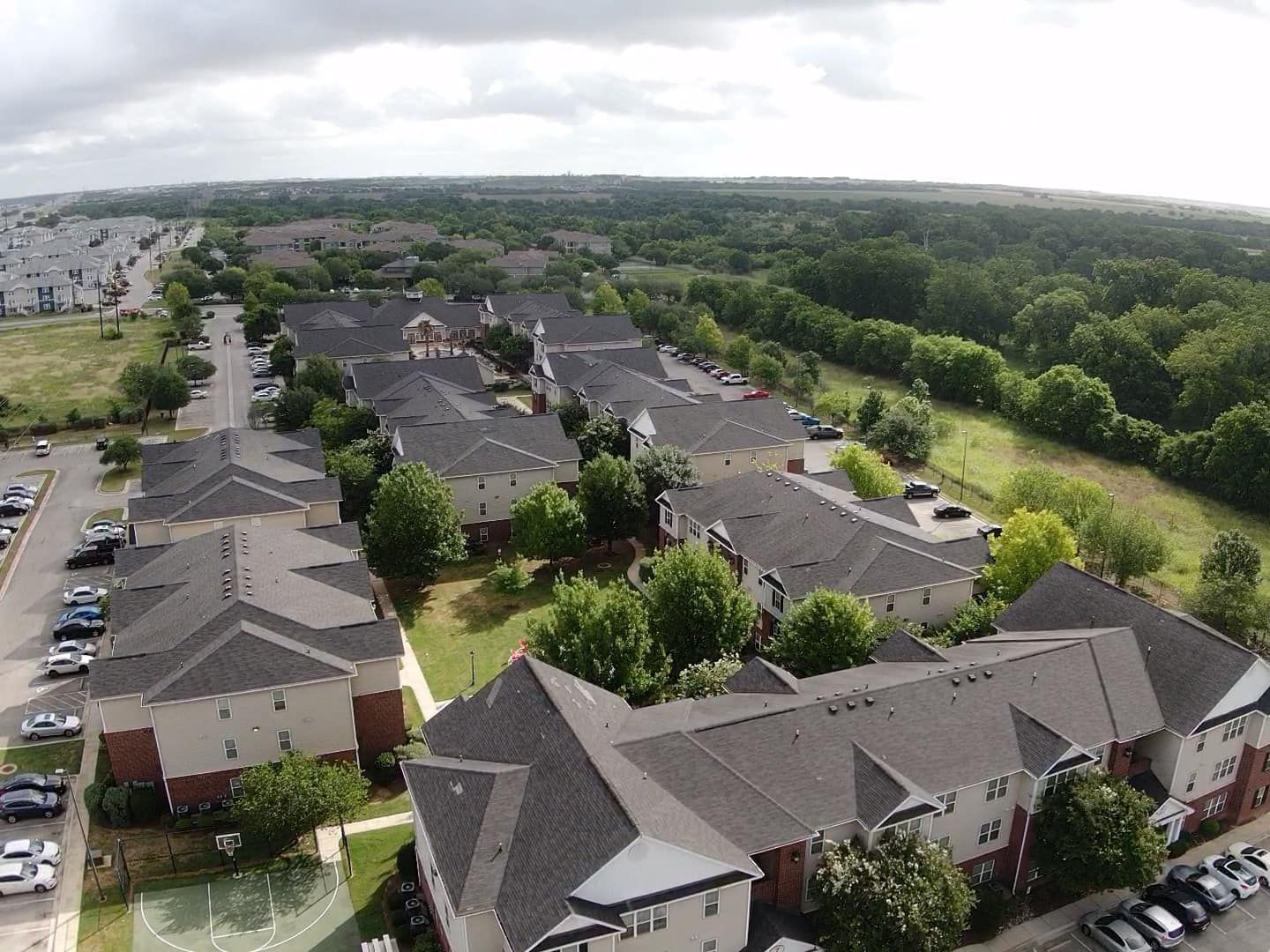 An aerial view of a residential area with lots of houses and trees