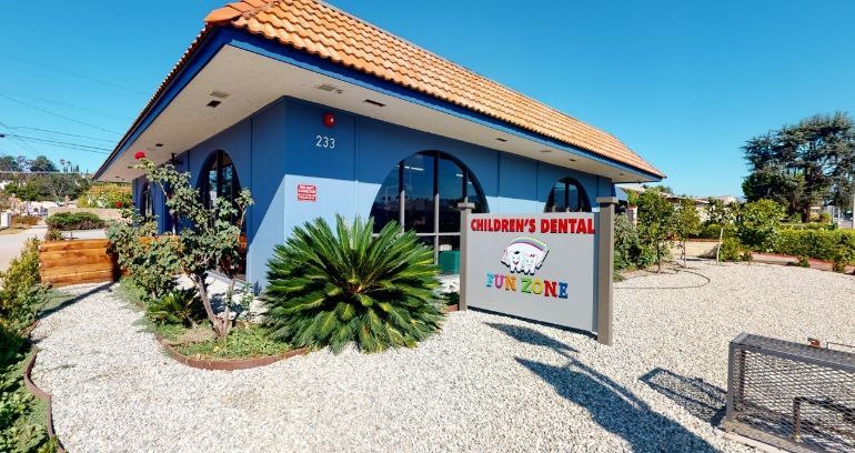 A blue building with a sign that says children 's dental