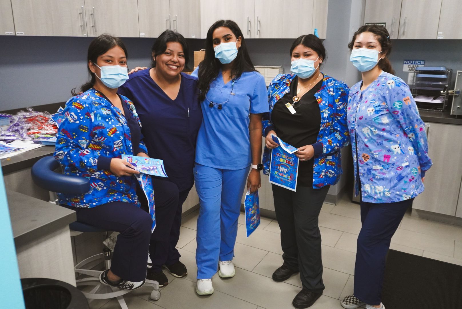 A group of nurses wearing masks are posing for a picture.