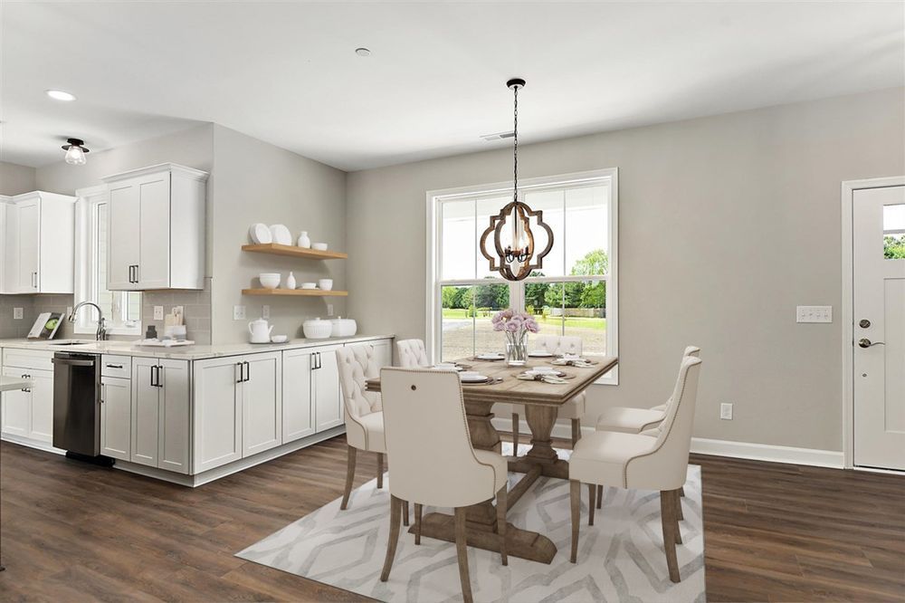 A kitchen and dining room in a house with a table and chairs.
