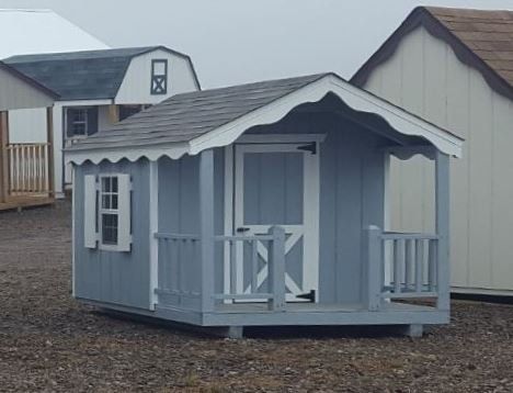 A small shed with a porch and a window