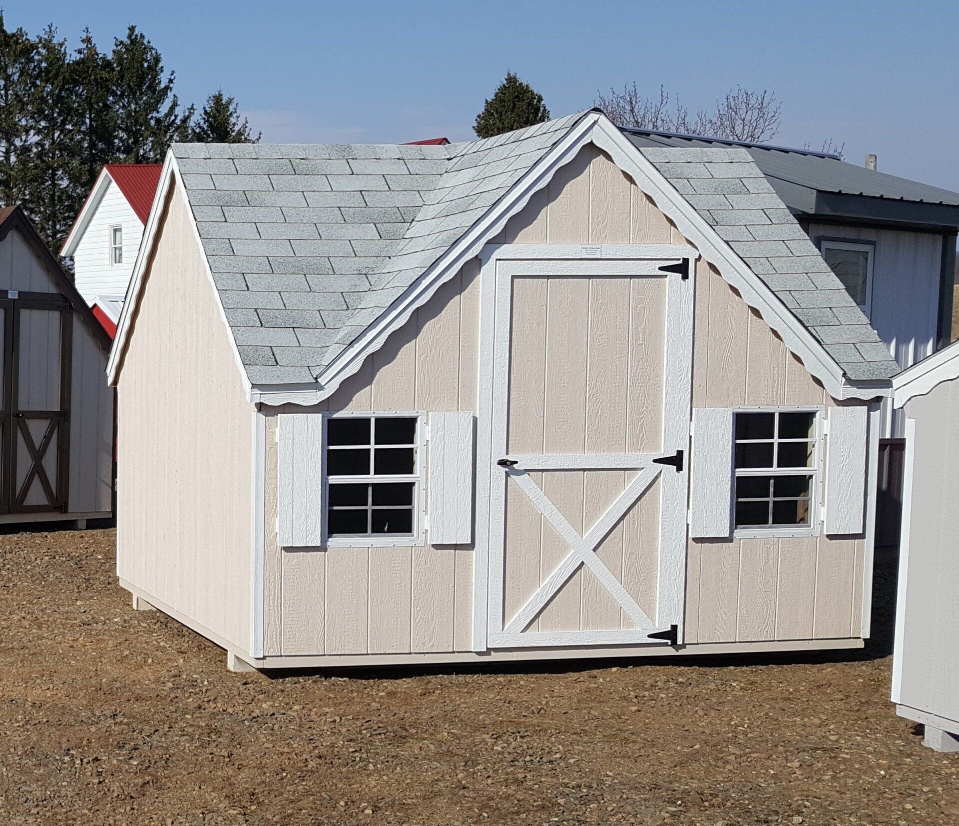 A small shed with a white door and shutters