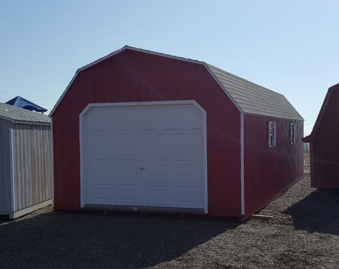 A red barn with a white garage door