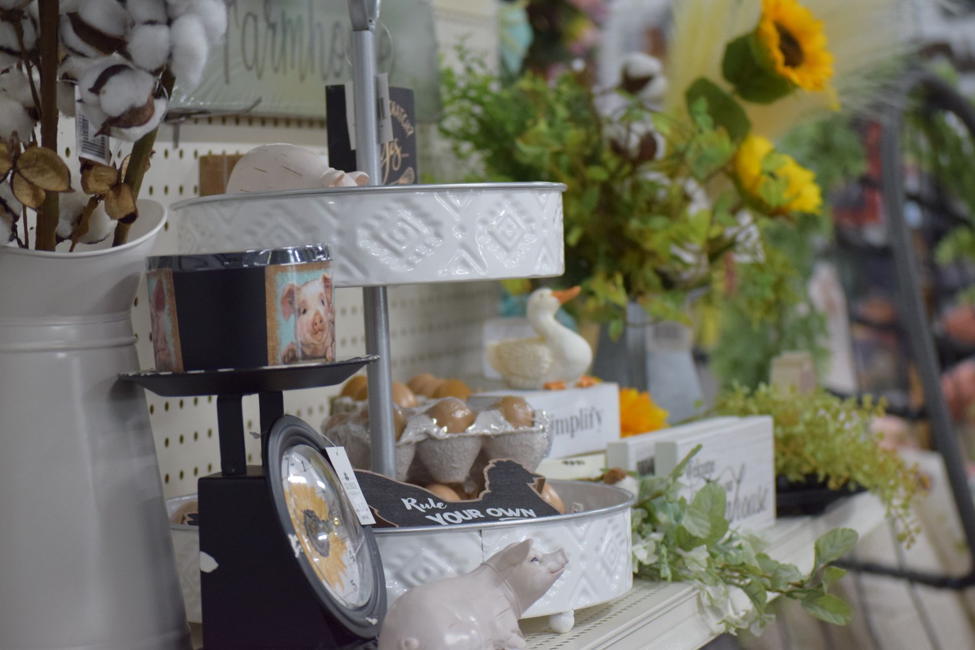 A three tiered tray is sitting on a table in a store.