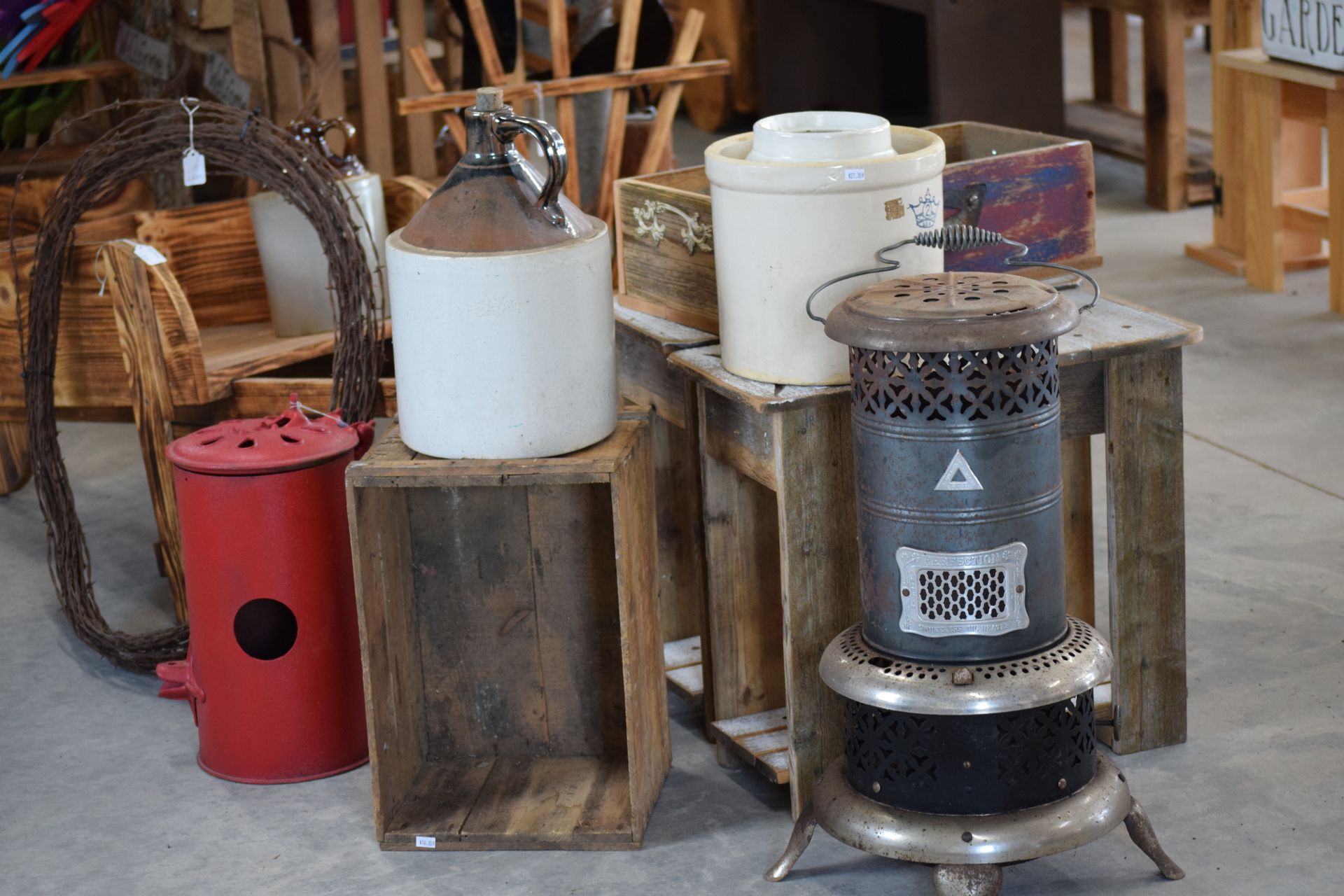 A group of old heaters are sitting on wooden crates in a room.