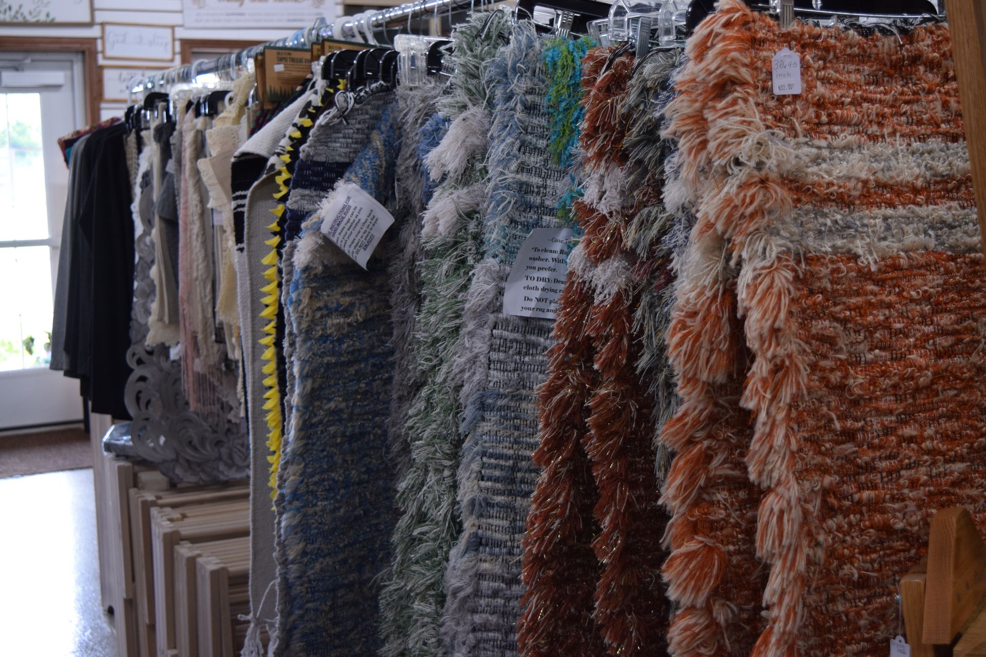 A row of sweaters hanging on a rack in a store