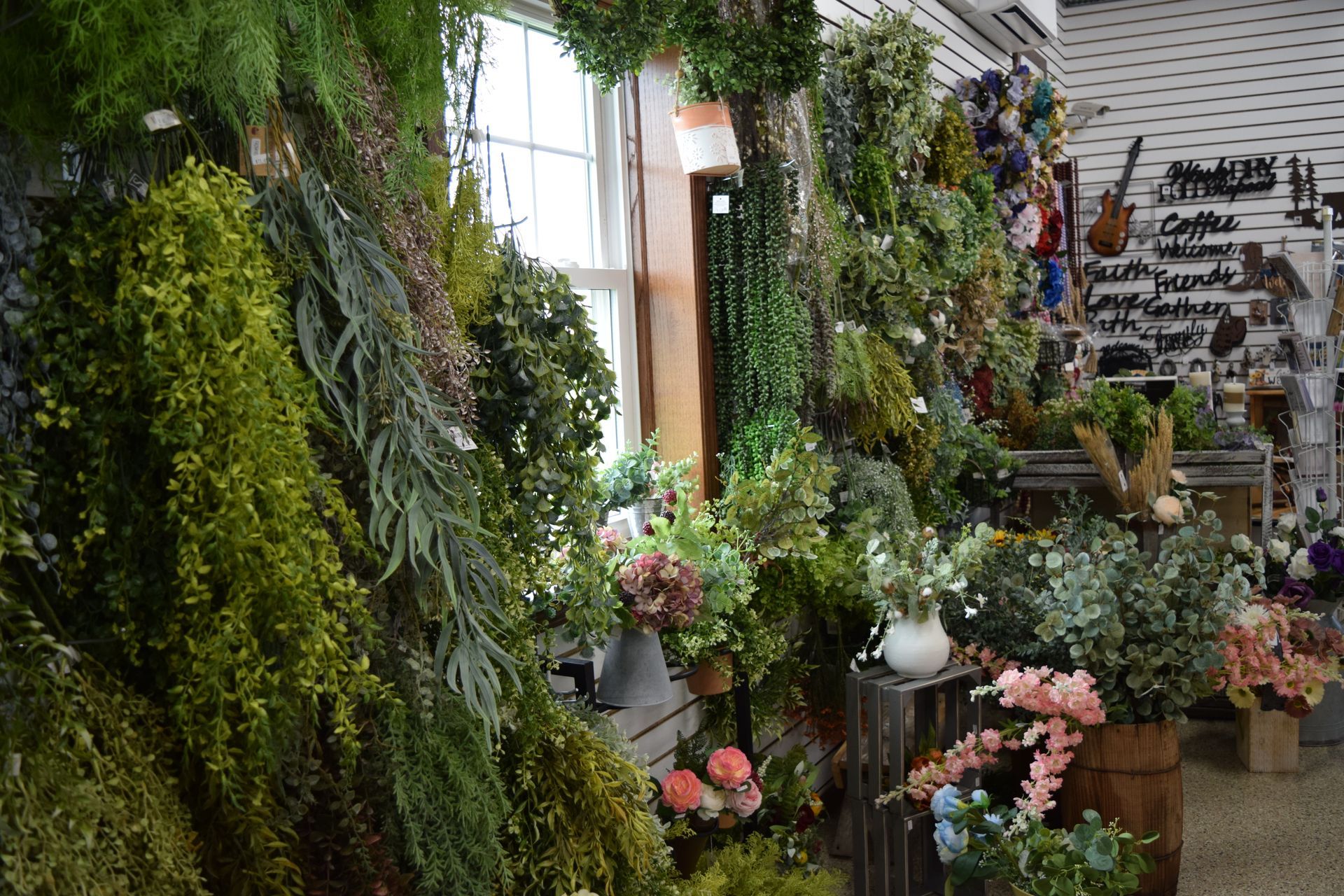 A room filled with lots of plants and flowers.