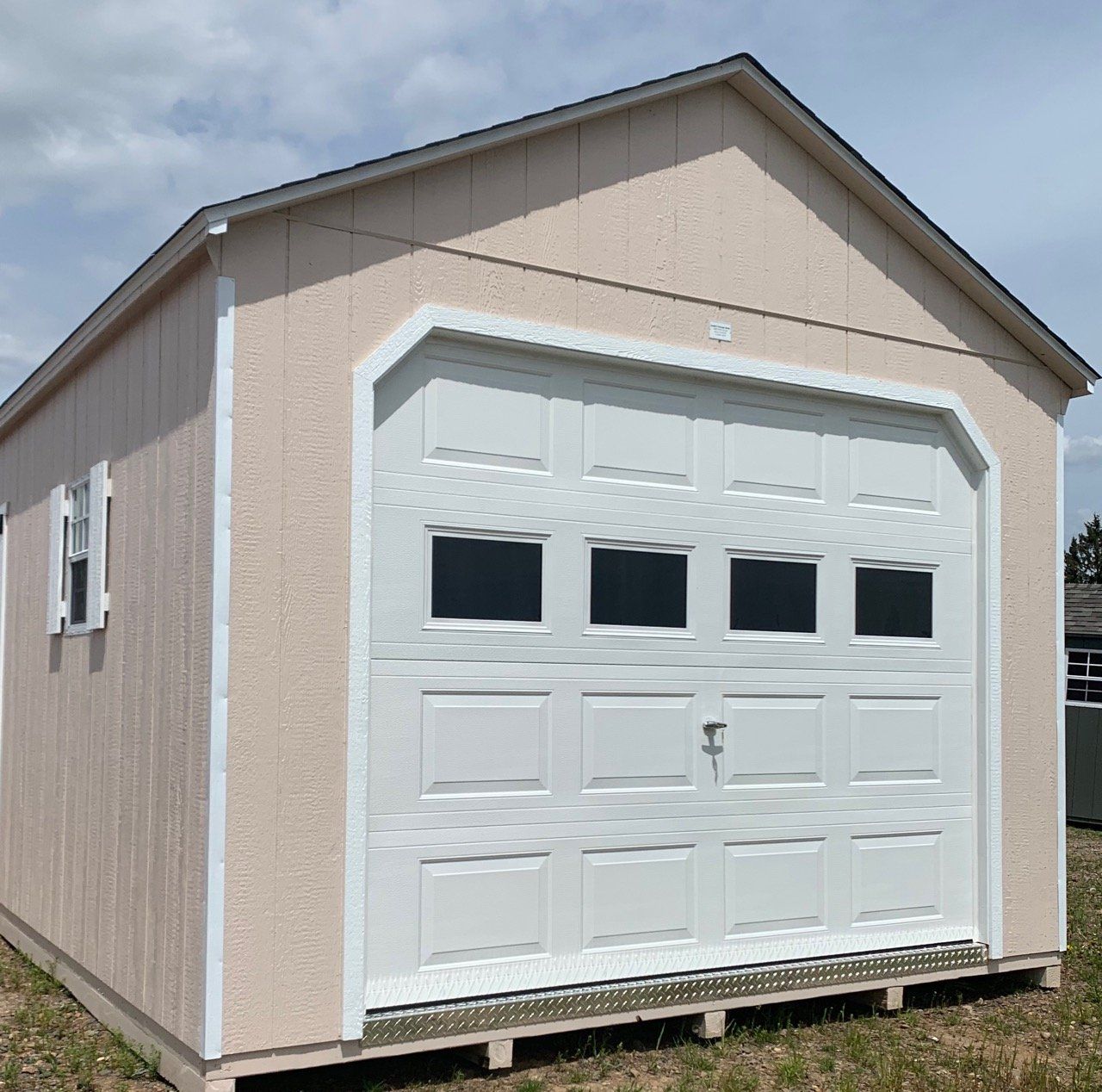 A garage with a large white garage door and windows