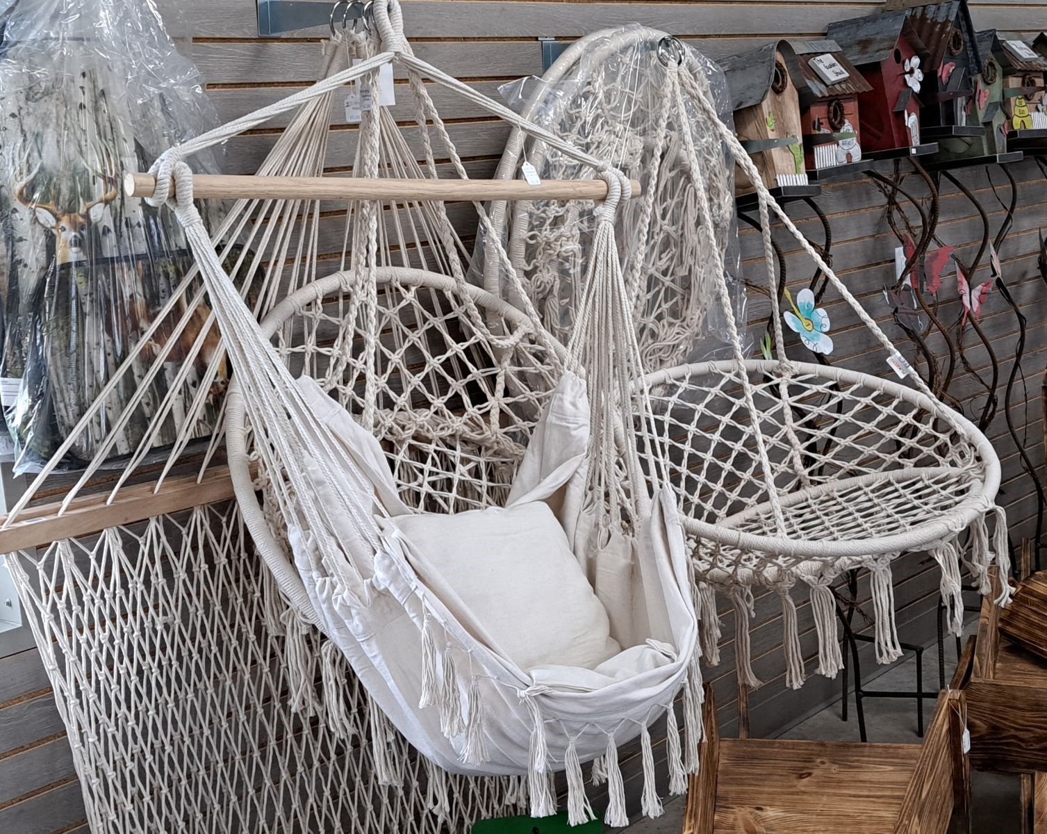 A white hammock chair is hanging on a wall in a store.