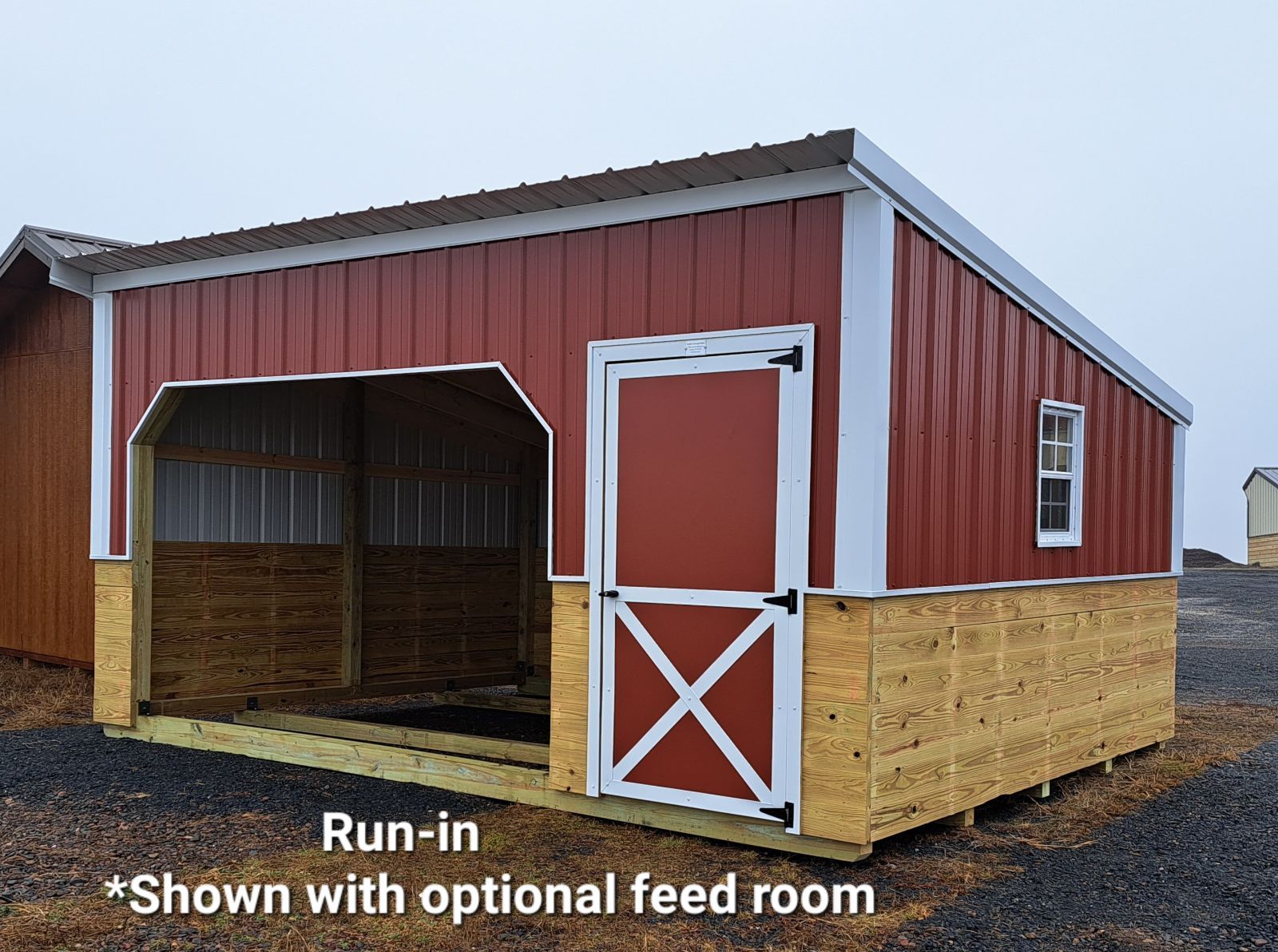 A red barn with a white door is shown with an optional feed room.