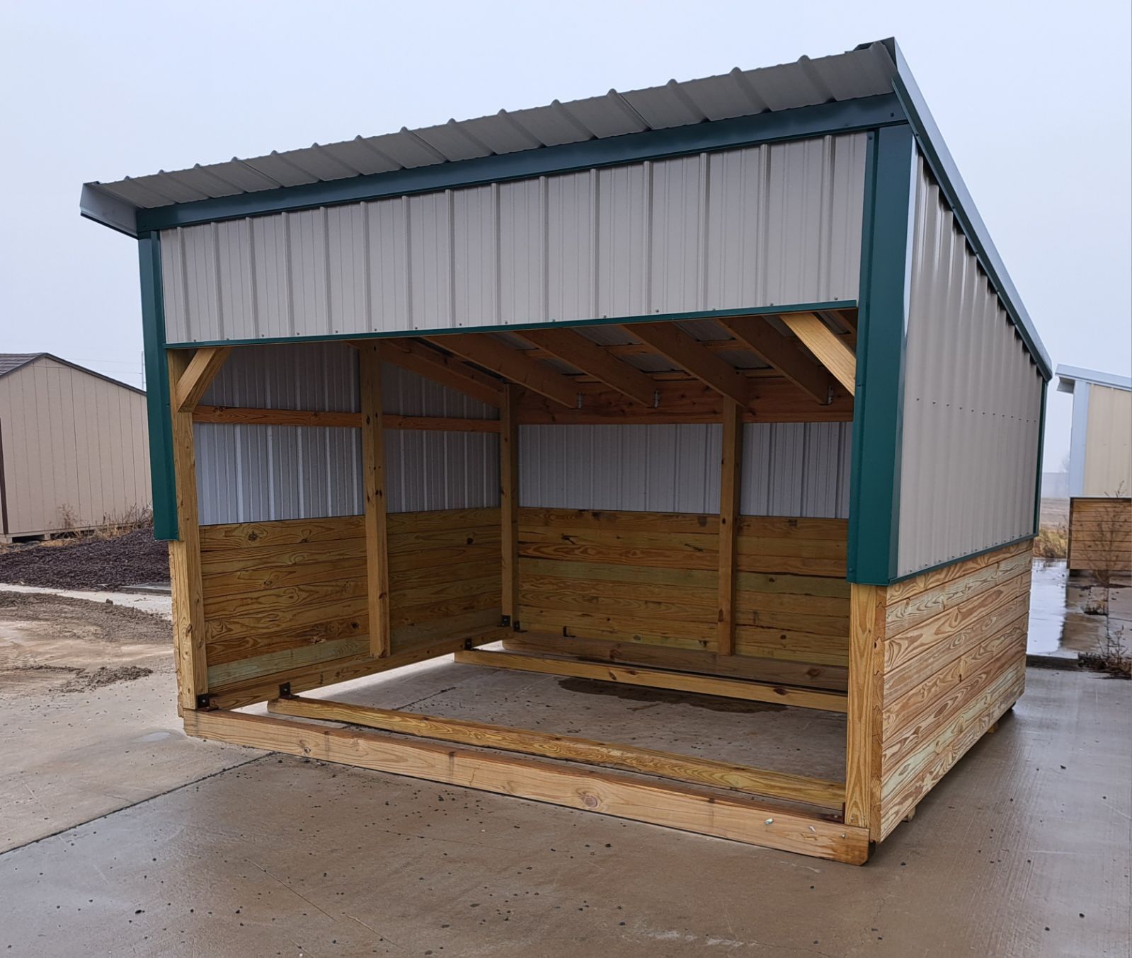 A small wooden shed with a metal roof