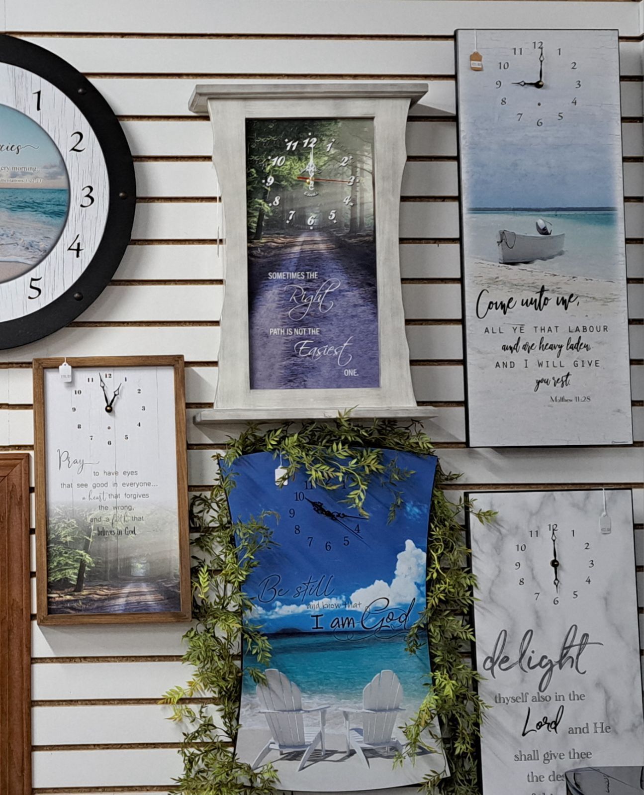 A wall with a bunch of clocks and pictures on it