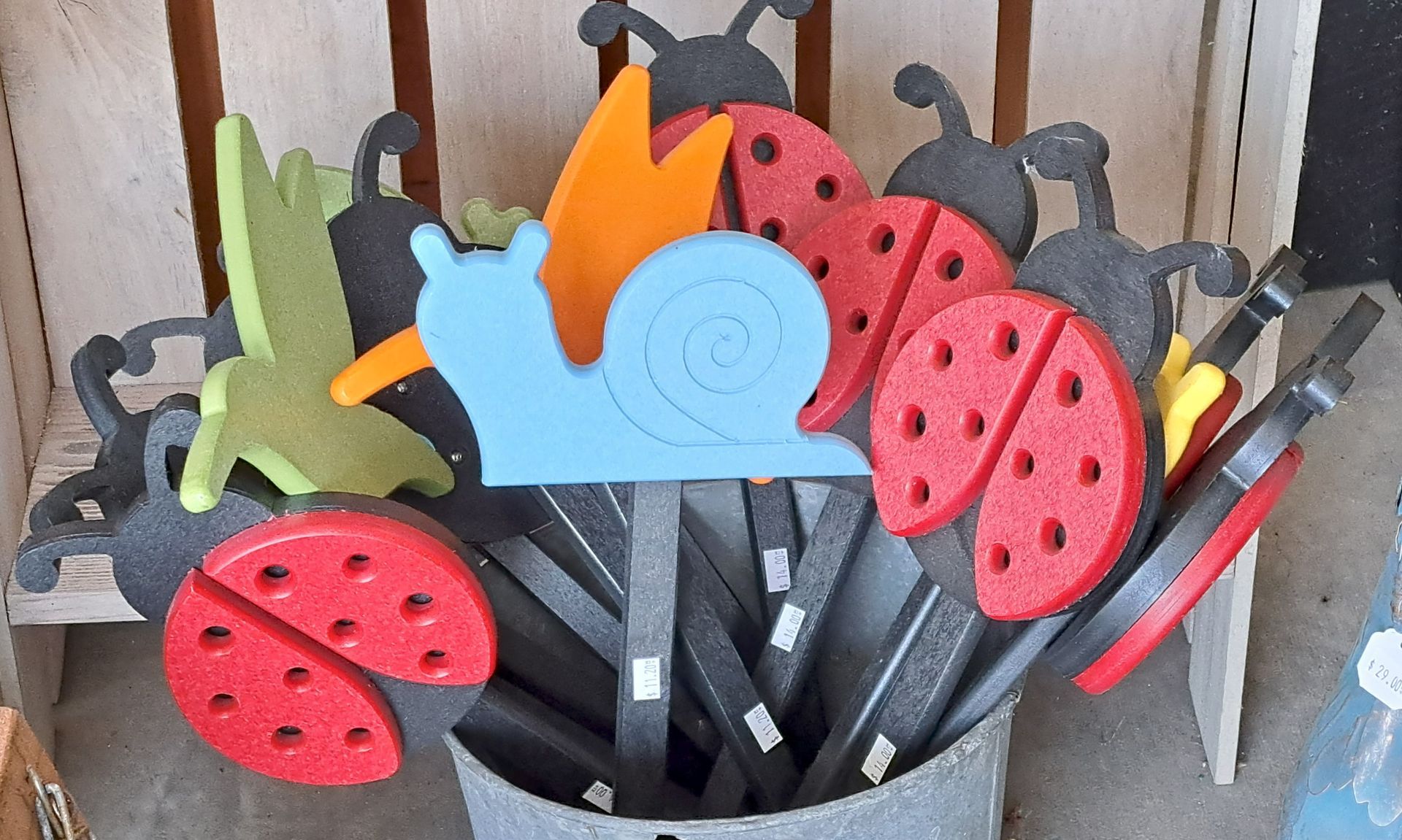 A bunch of ladybugs and a snail are in a bucket