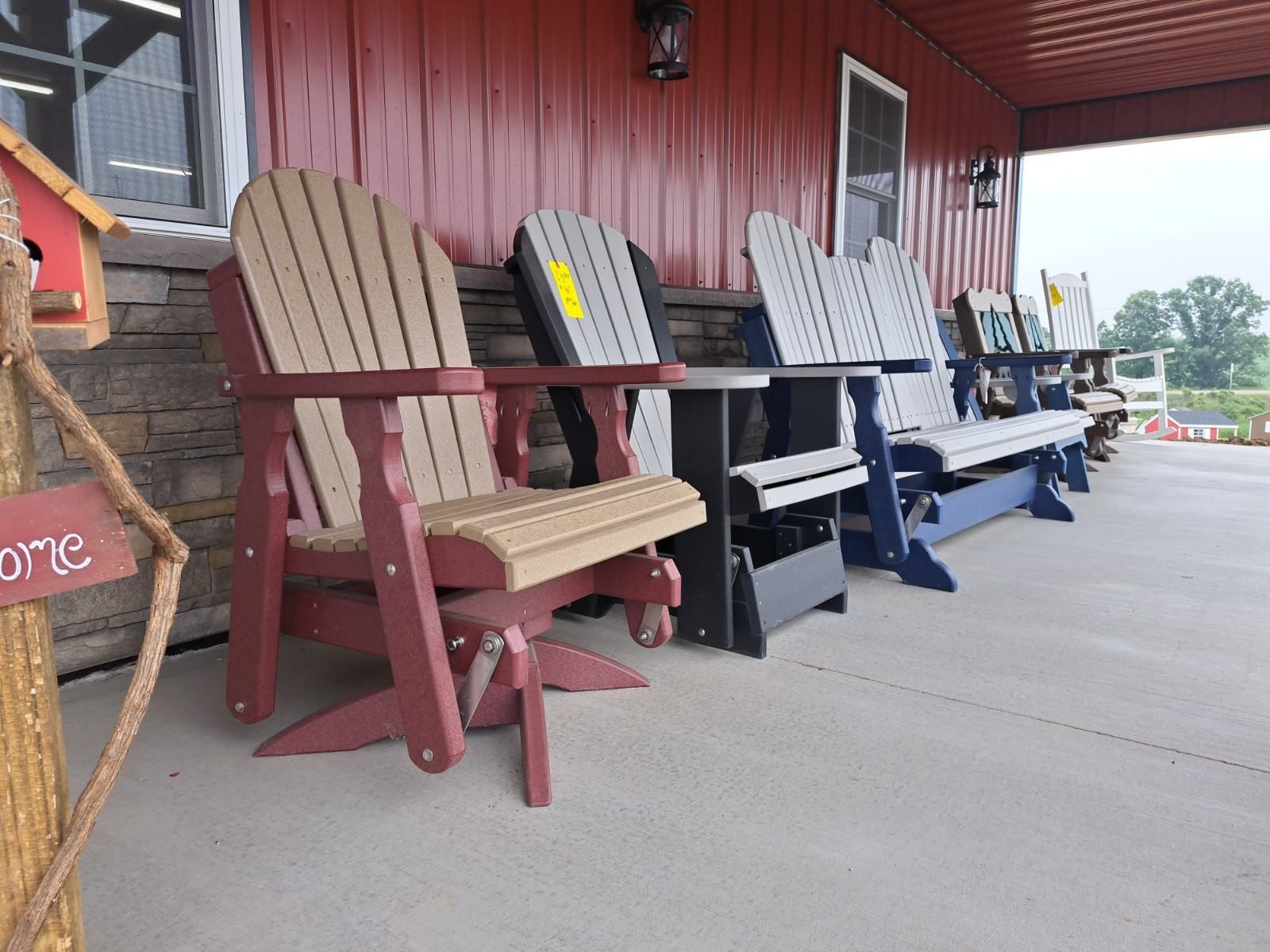 A row of chairs are lined up in front of a red building.