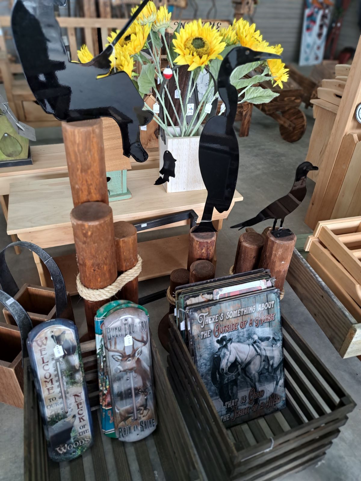 A table with a vase of sunflowers on it