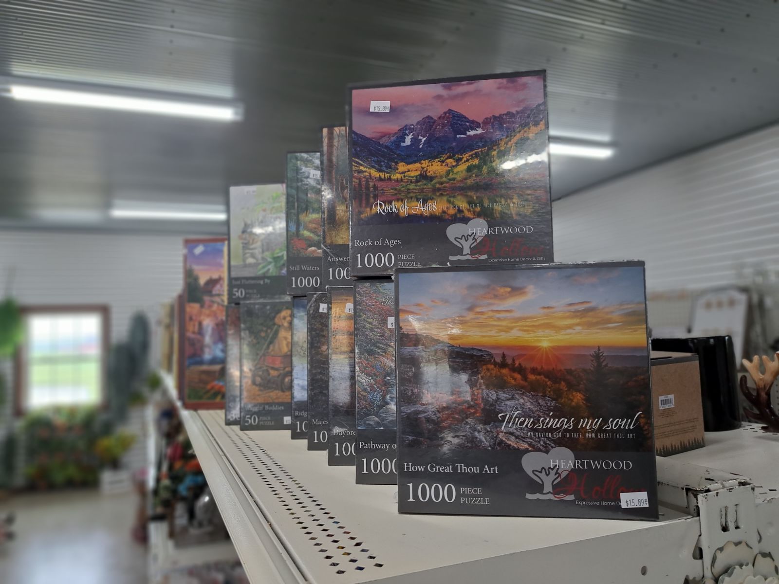 A row of puzzles sitting on top of a shelf in a store.