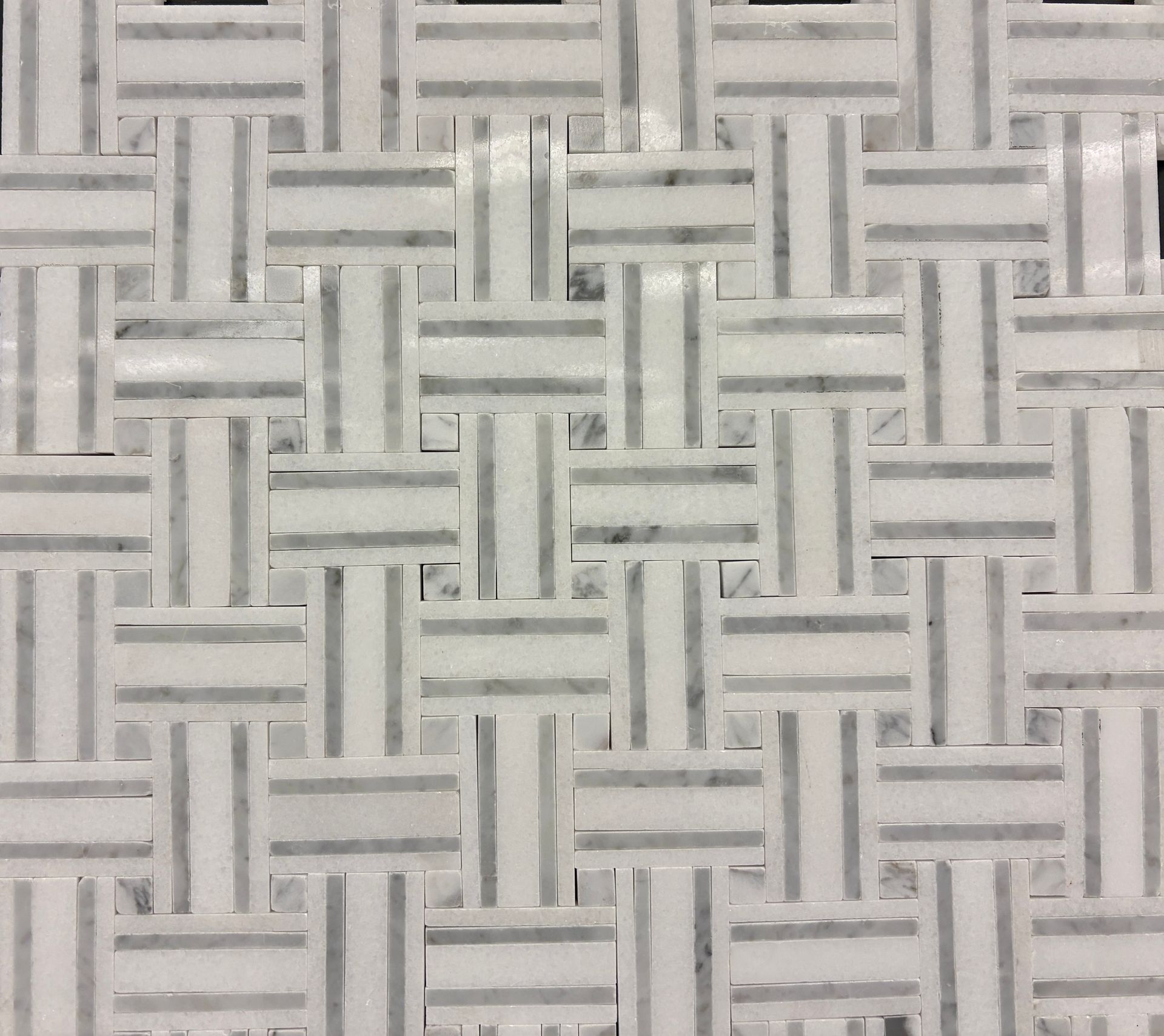 White kitchen cabinets and countertops with patterned backsplash.