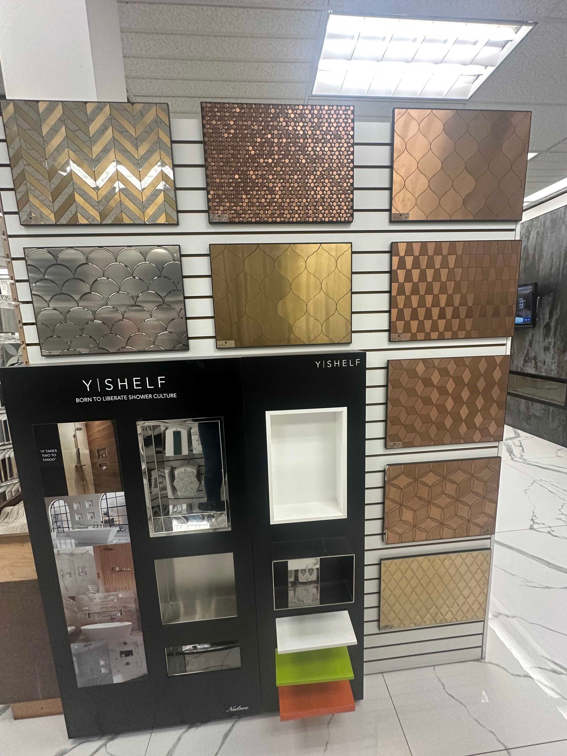 Tile samples in various textures and colors displayed on a retail panel.
