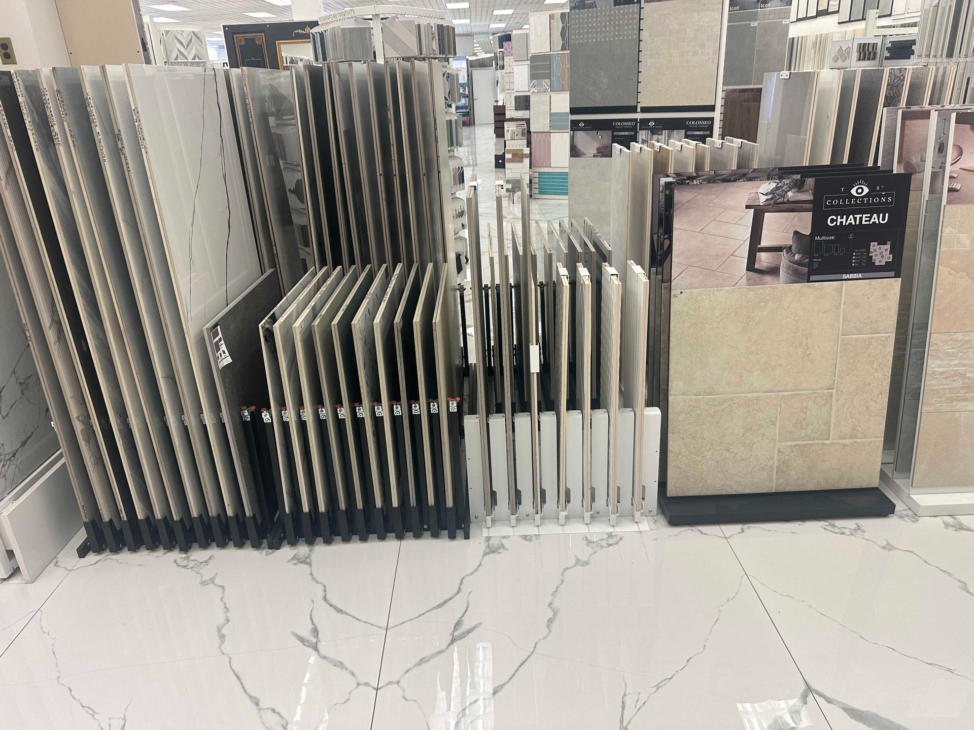 Tile samples on display in a store, showcasing various colors and patterns.