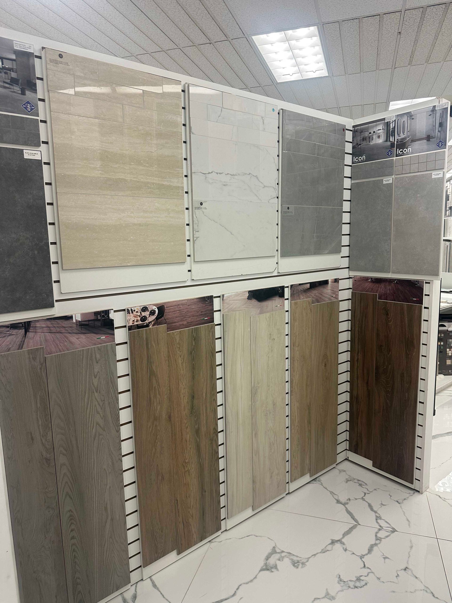 Tile samples displayed on racks in a showroom, various colors and textures.