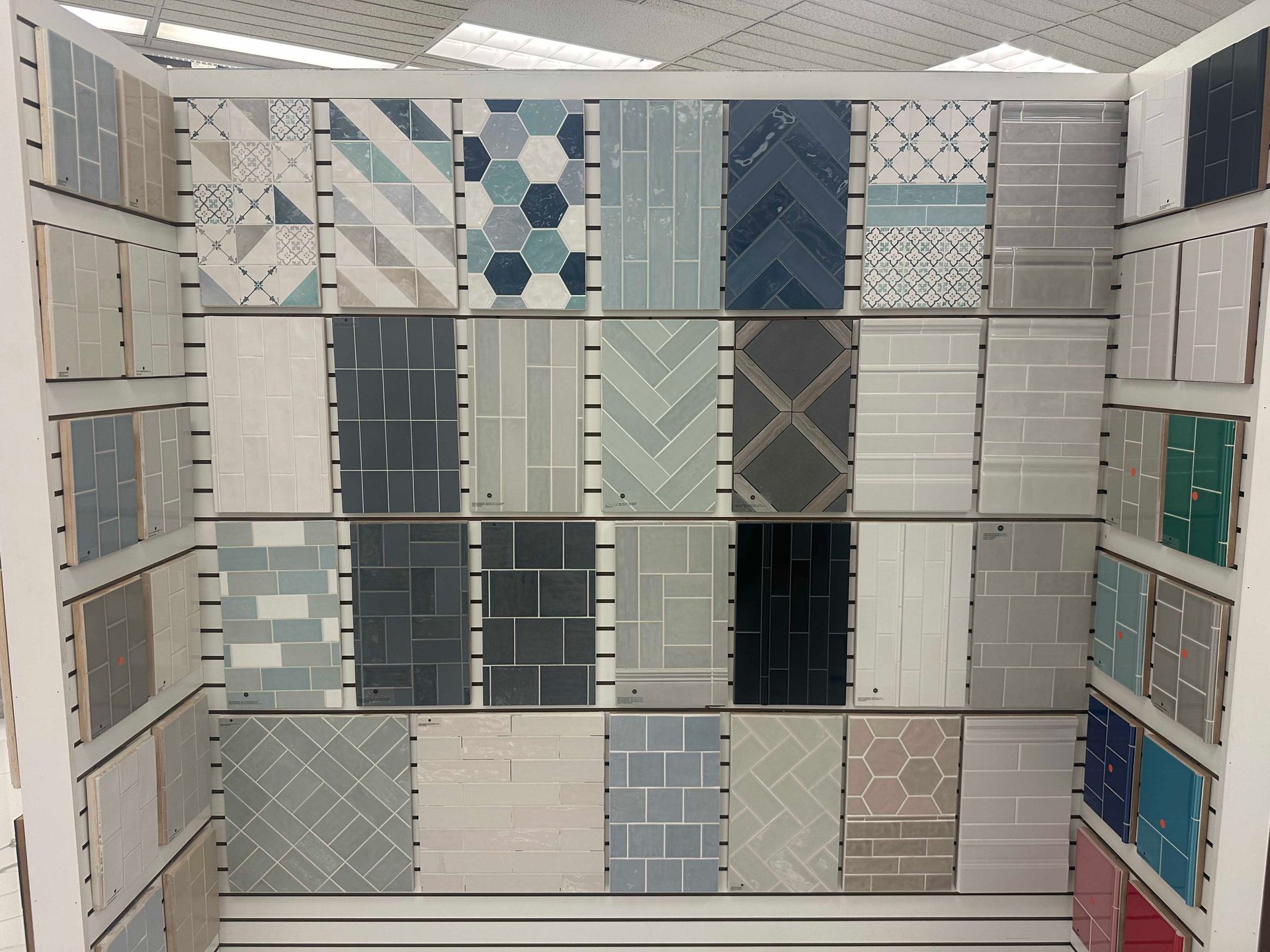 Tile samples on display, various patterns and shades of gray, blue, and white.
