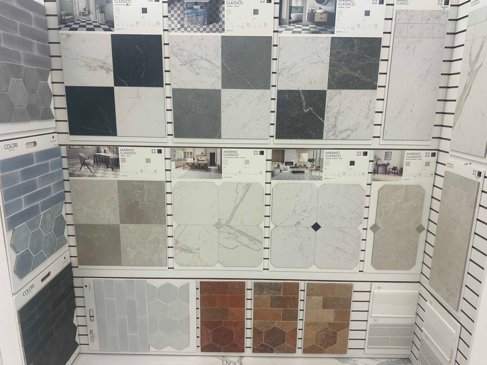 Display of various floor tile samples in a store, showcasing different patterns and colors.