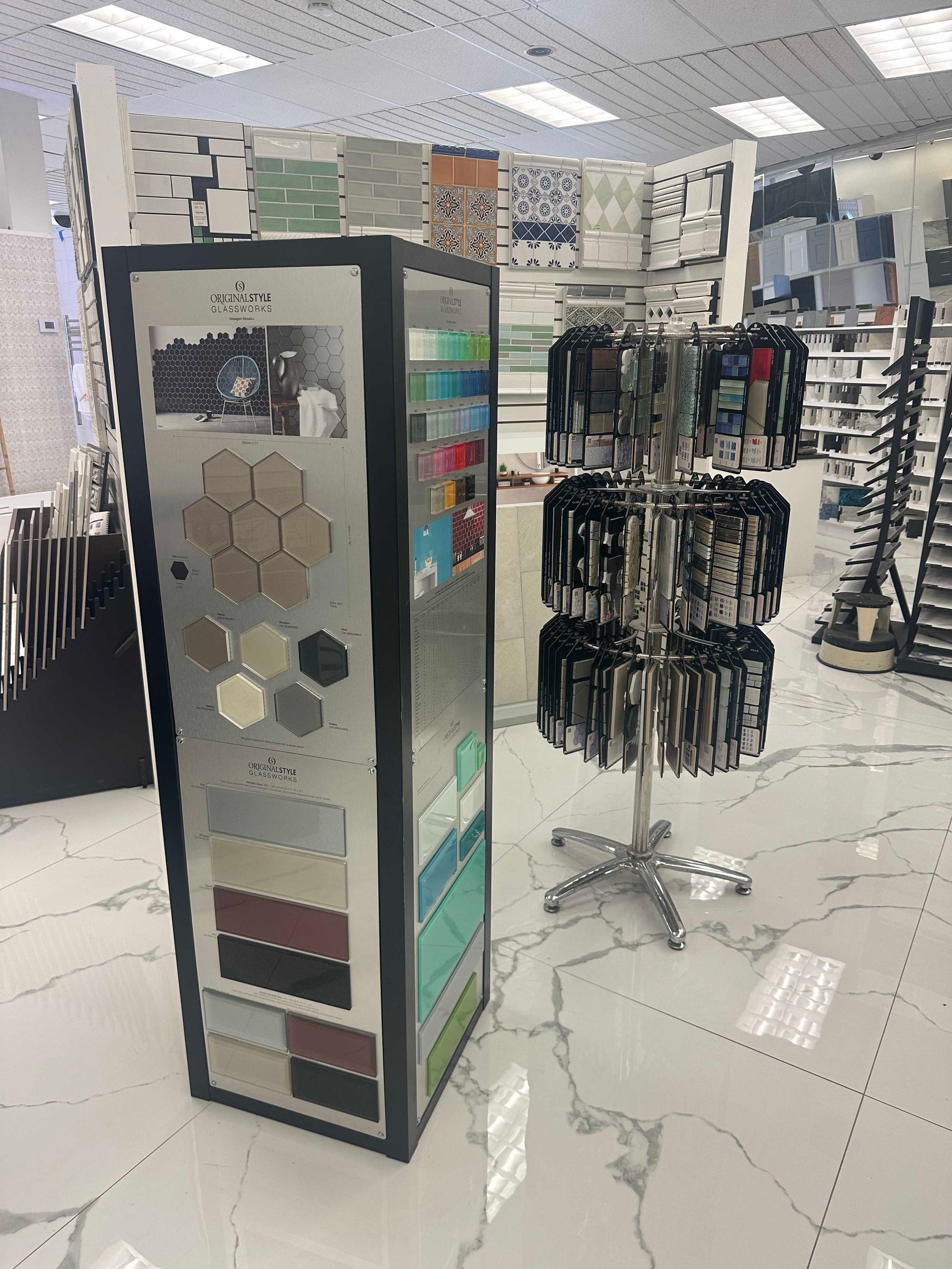Tile showroom with a display of tile samples and a rotating rack of trim.
