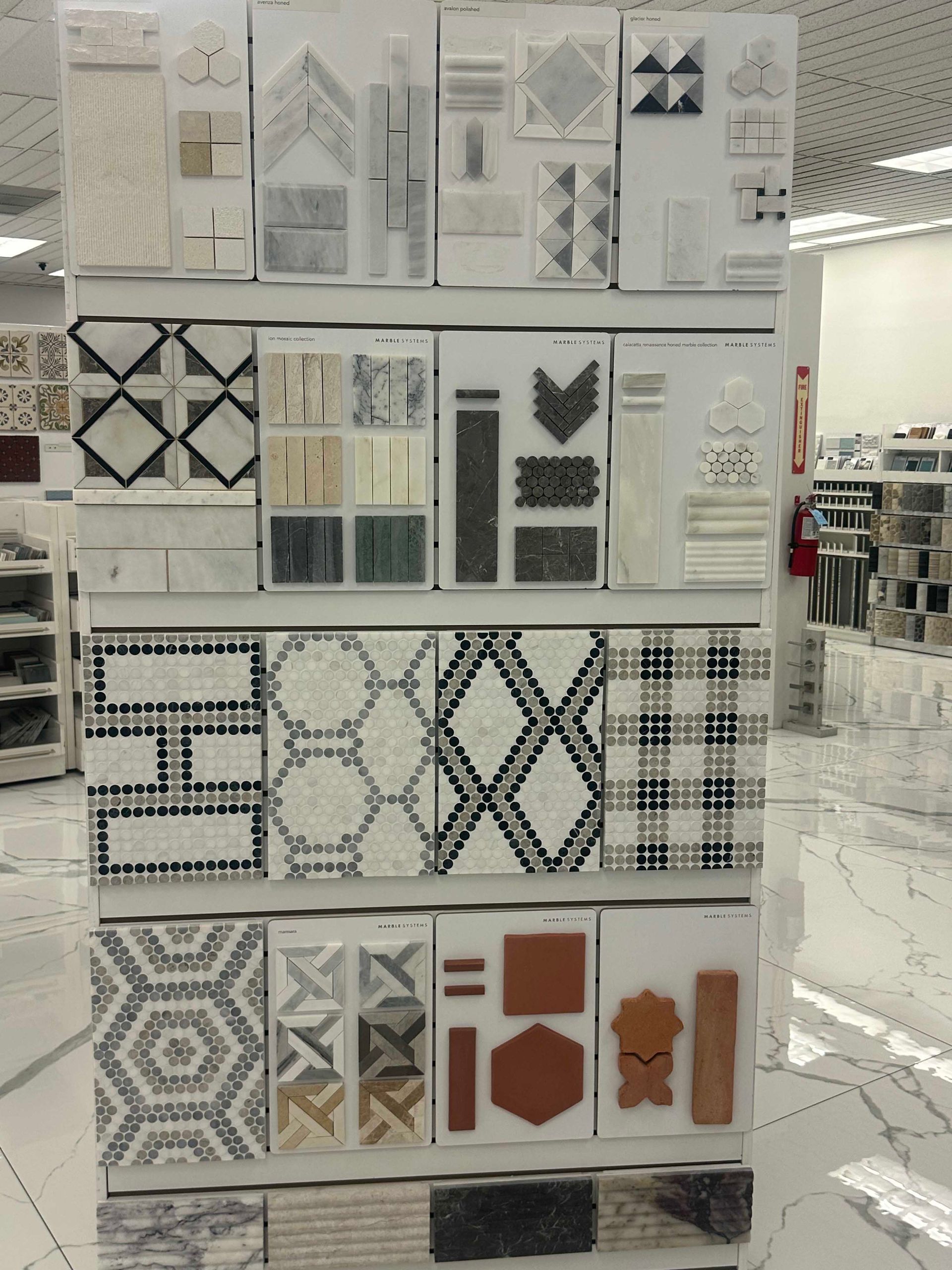 Display rack of various tile samples in a store, showcasing different patterns and colors.
