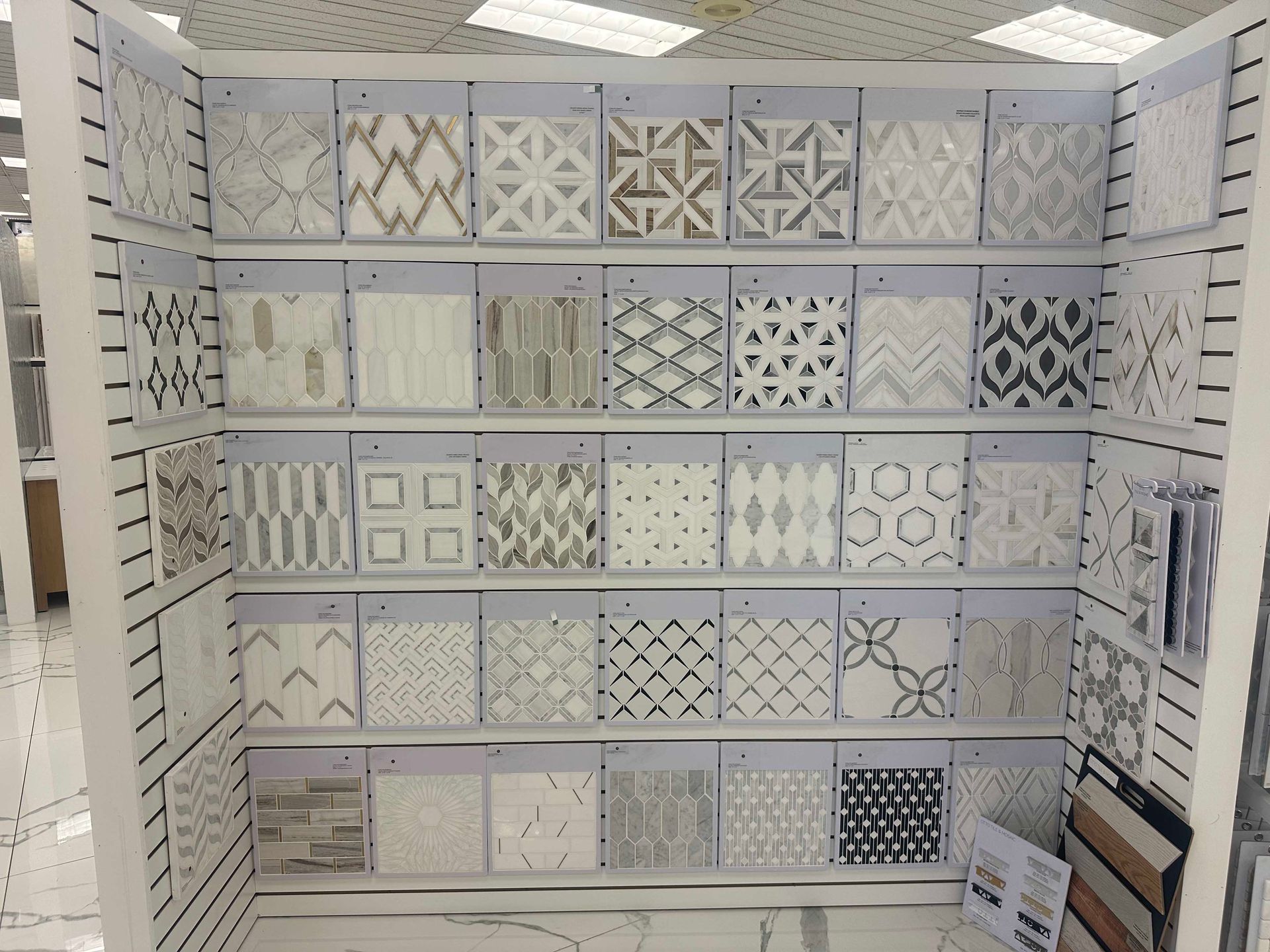 Tile display with various patterned samples in a store.