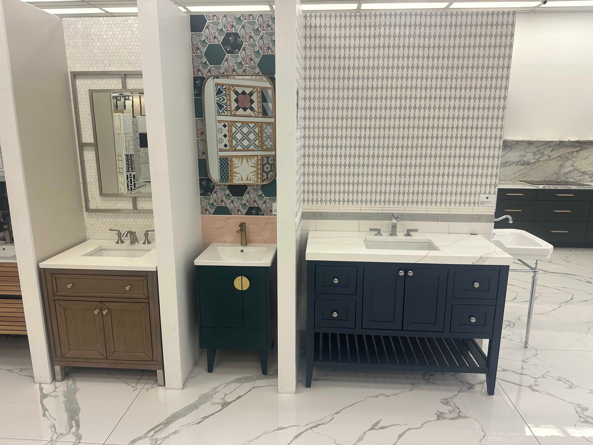 Bathroom vanities in a showroom, featuring various cabinet styles, colors, and countertop materials.
