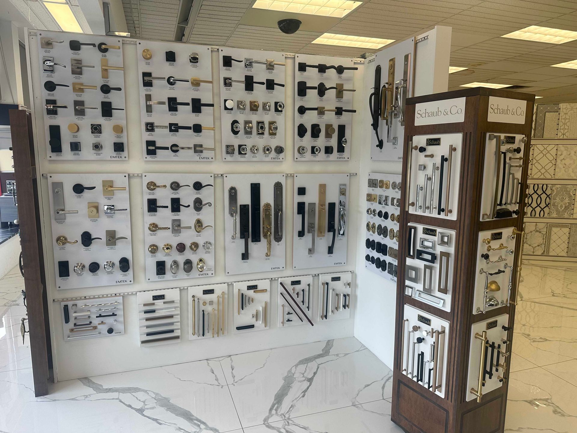 Display of various door handles and hardware in a showroom setting.