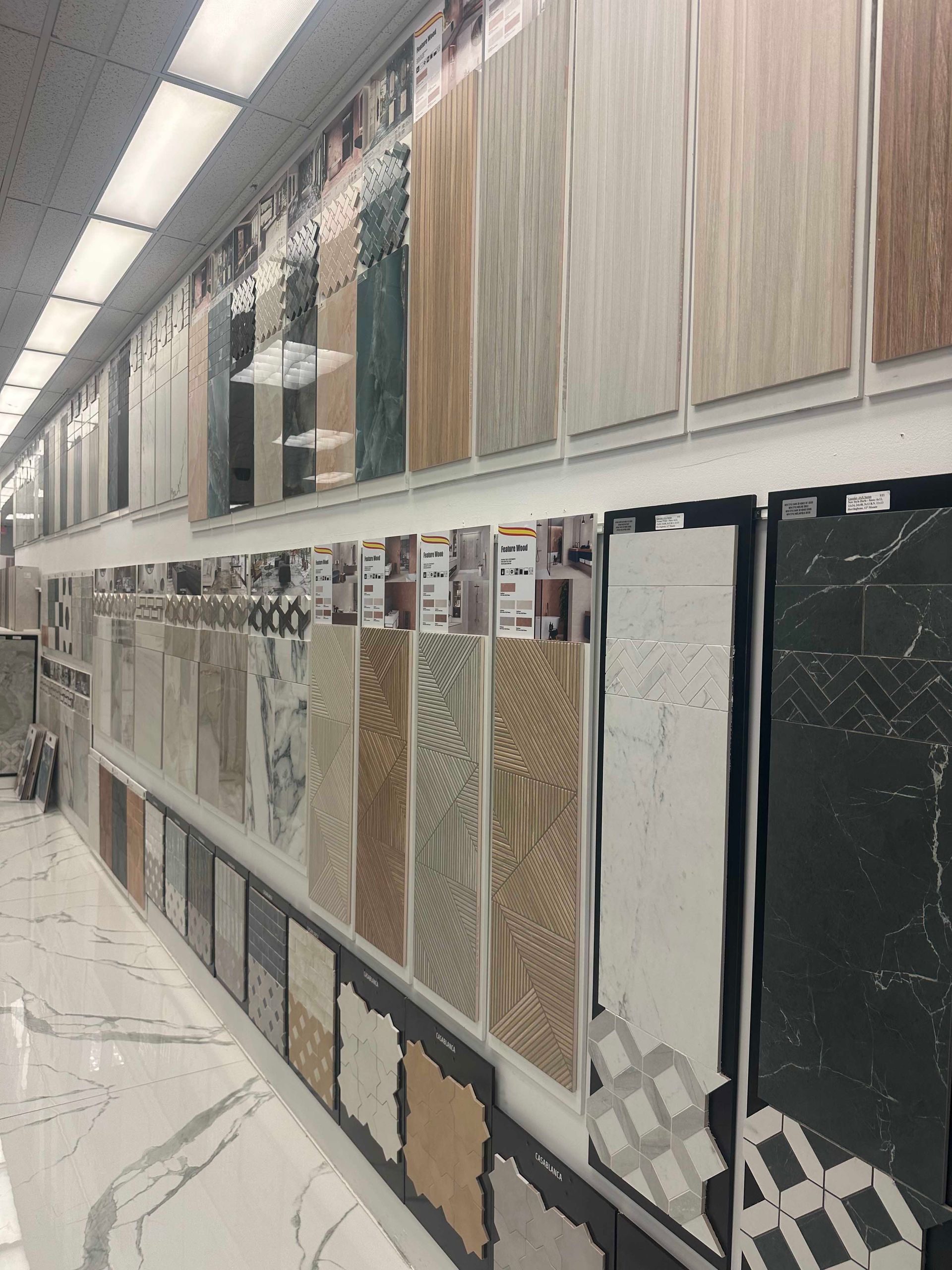 Tile samples displayed on a store wall, varying colors and textures.