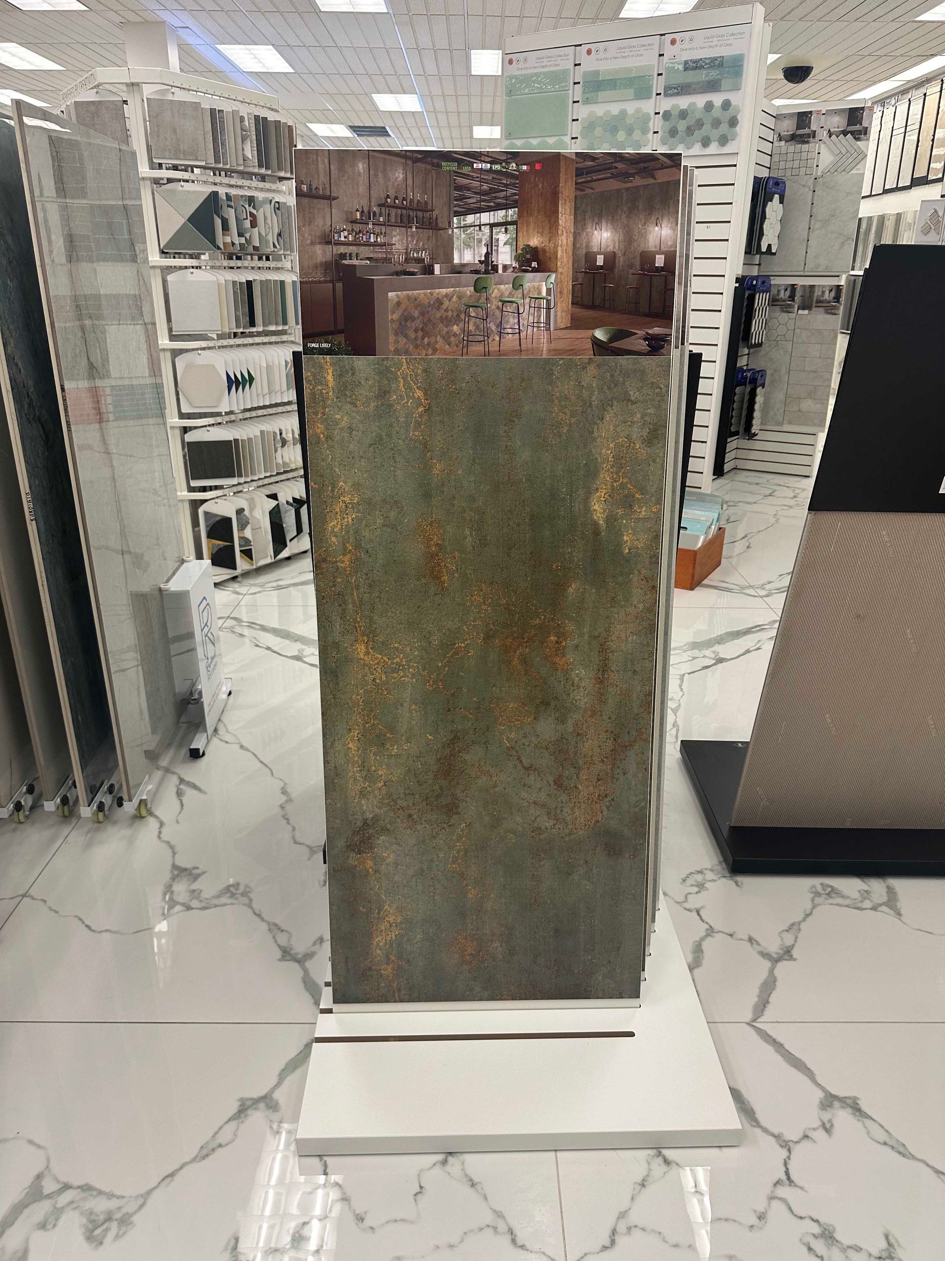 Display of rustic-looking tiles in a tile store, showing a bar scene.