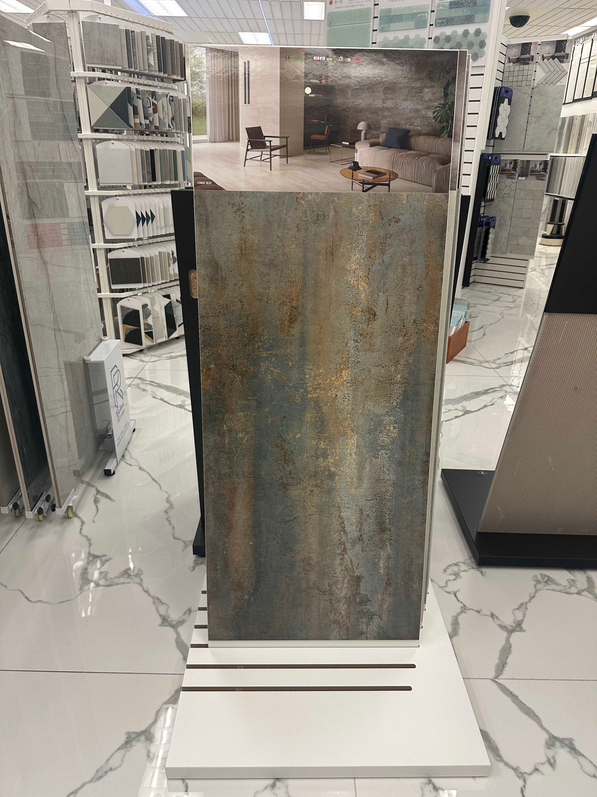 A large, rectangular tile with a textured, rusty-brown and gray finish displayed on a white stand in a store.