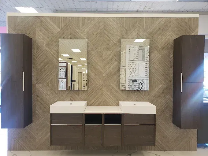 Bathroom vanity with brown cabinets, white countertop, mirrors, and beige patterned wall.