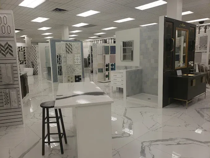 Tile showroom interior with many displays featuring various tile styles. White floors.