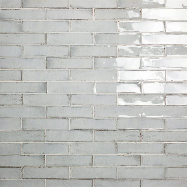 Light blue rectangular ceramic tile wall.
