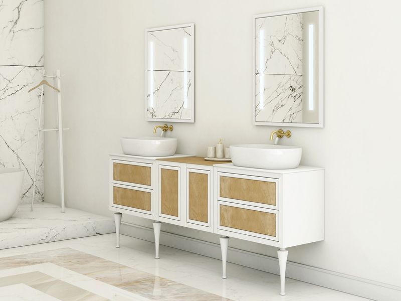 Bathroom with white vanity, marble-like mirrors, and vessel sinks. Light fixtures, golden hardware, and light wood accents.