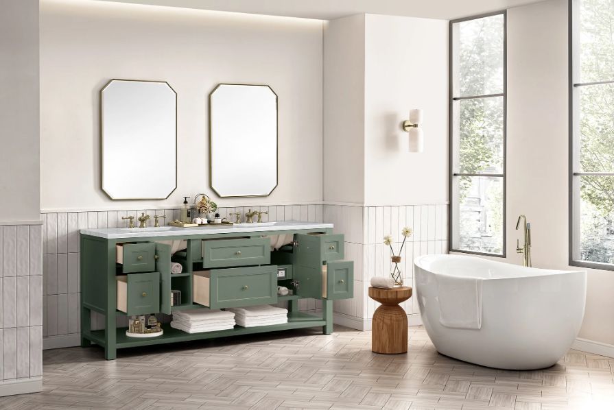 Bathroom with green double vanity, white tub, two mirrors, and a window.