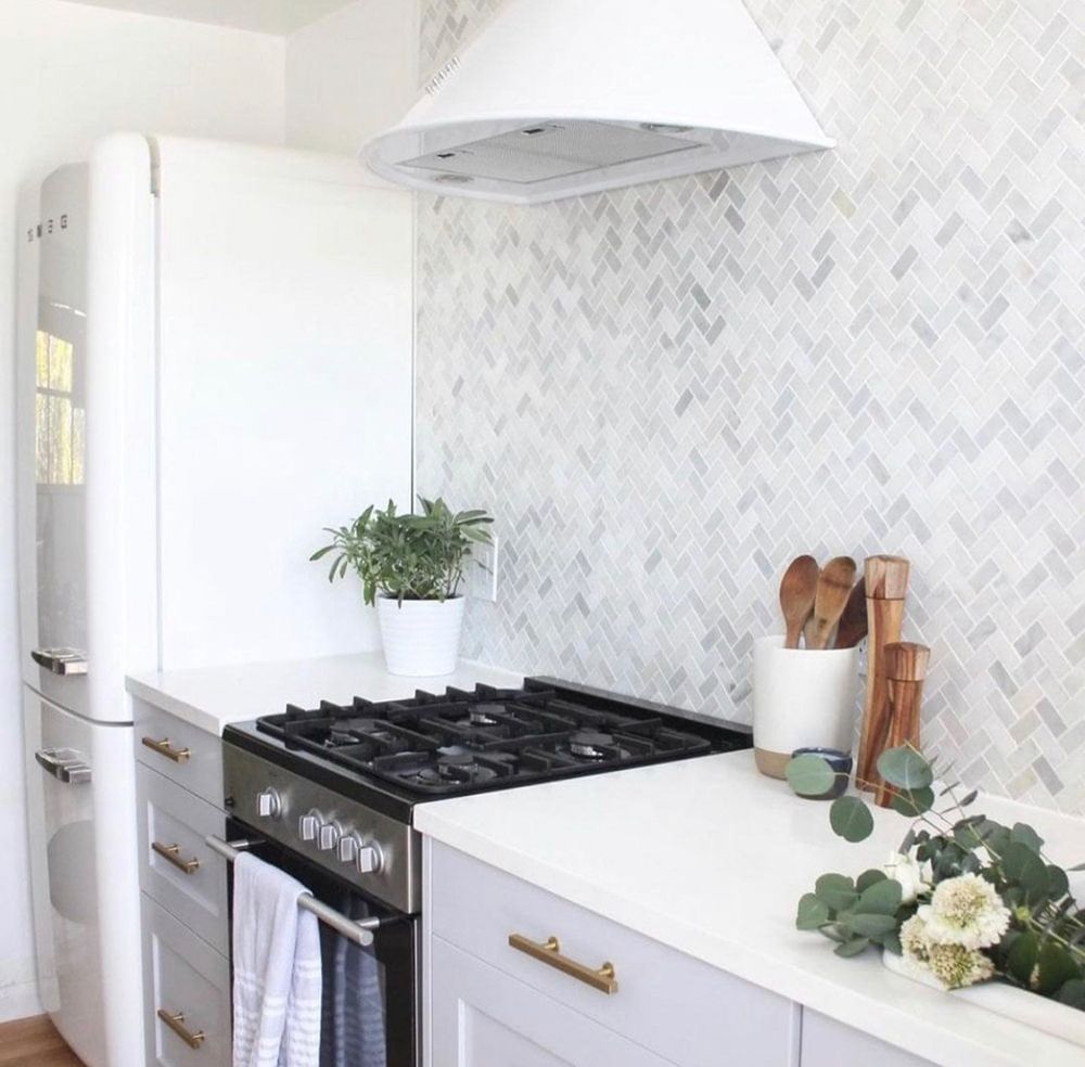 White kitchen with gray cabinets, marble backsplash, retro refrigerator, and stove.