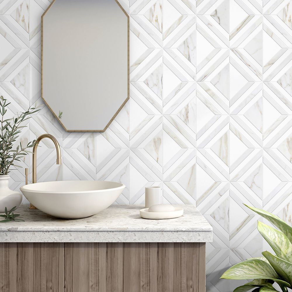 Bathroom with a white marble diamond tile wall, gold fixtures, and a wooden vanity.
