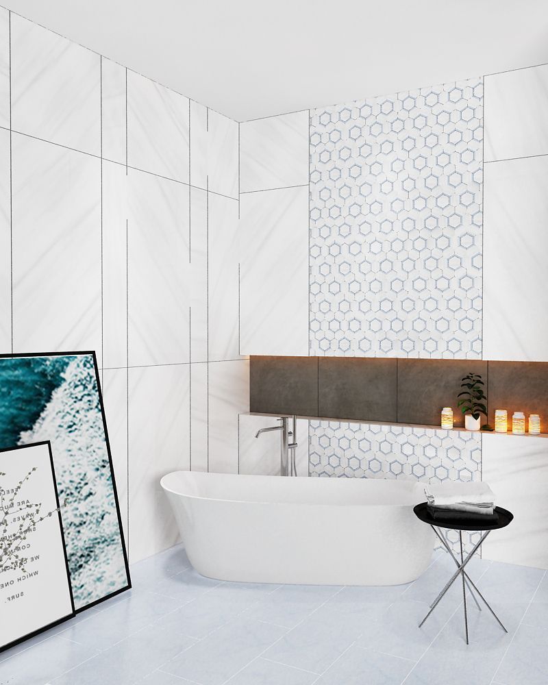 Modern white bathroom with tub, art, and patterned tile accent.