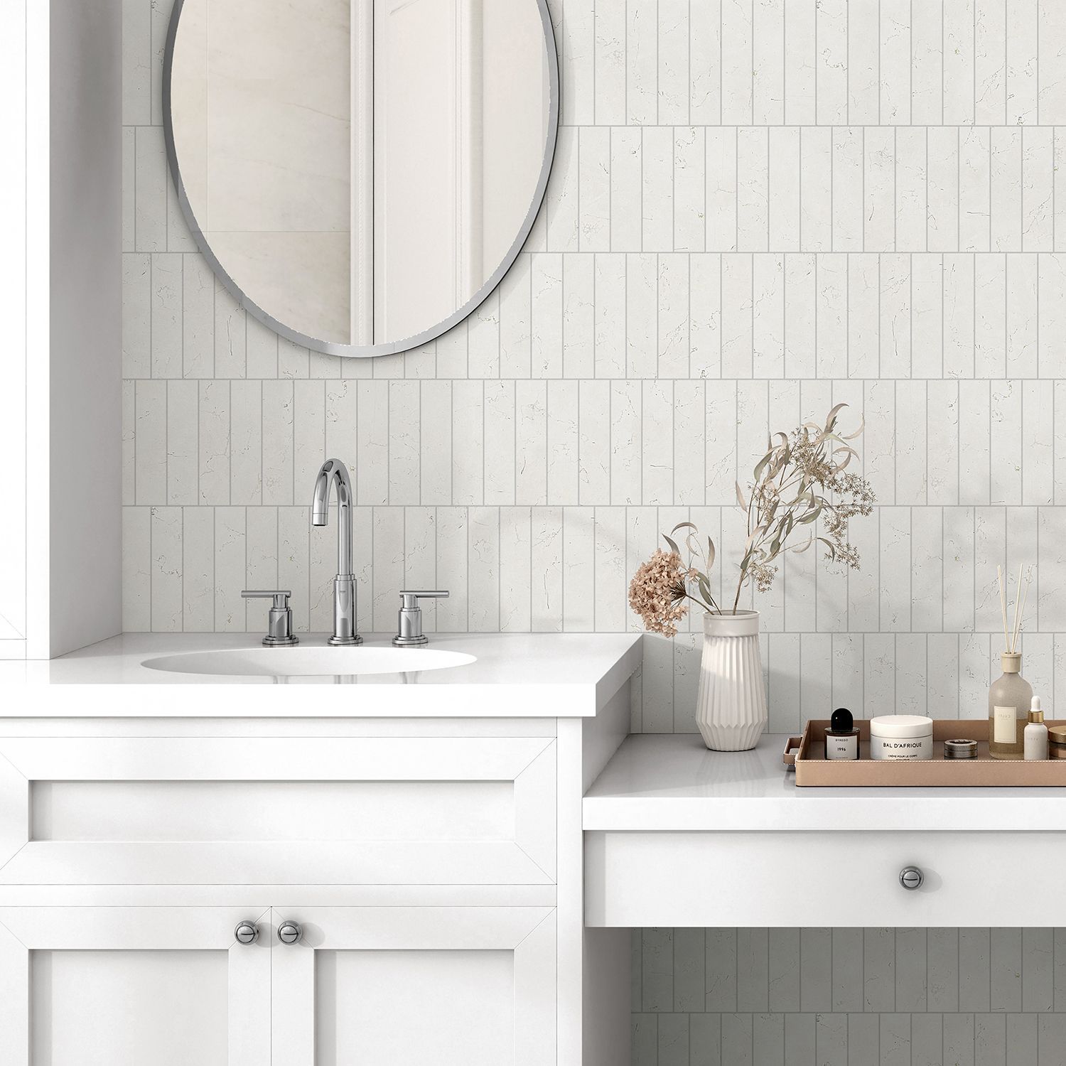 White bathroom with a sink, mirror, and decorative items on the countertop.