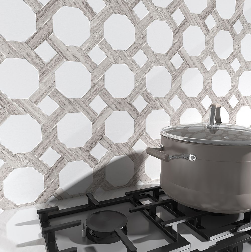 Kitchen with gas stove, pot, and white tile backsplash with wood-look pattern.