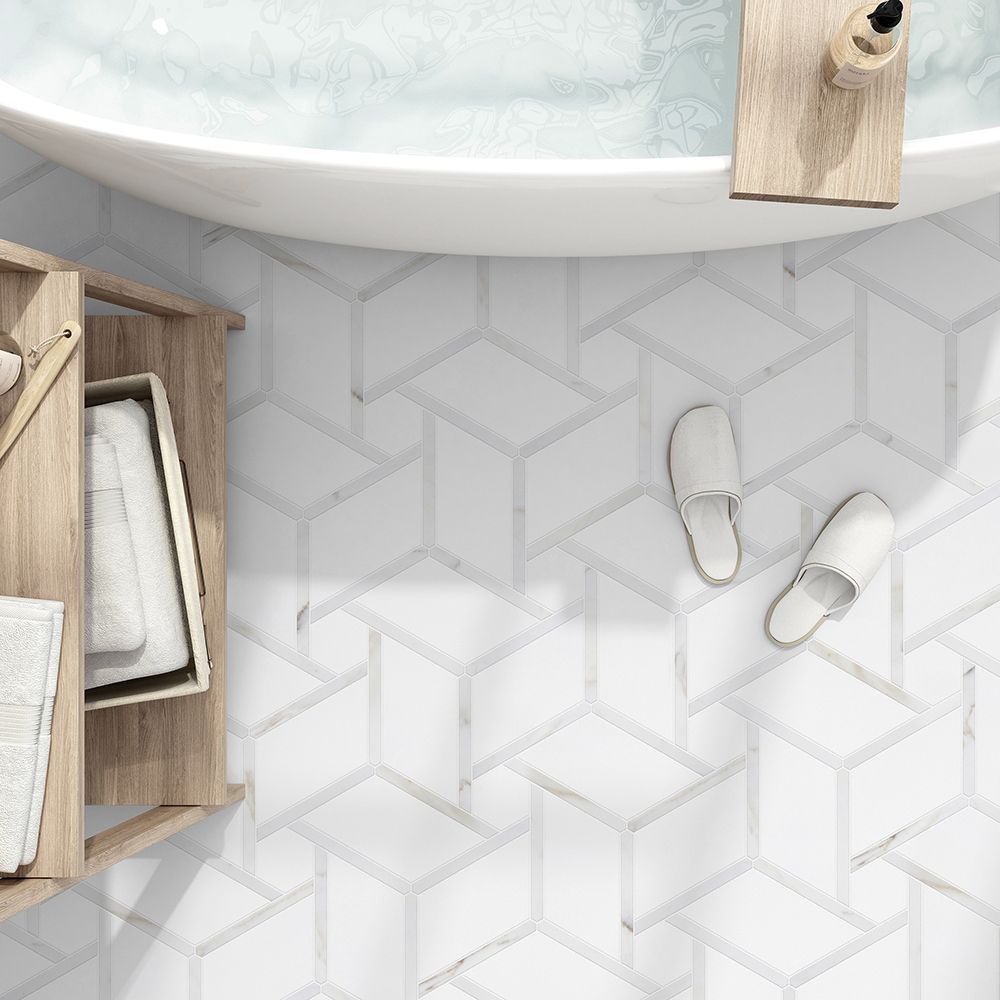 Bathroom with white geometric tile, wooden cabinet, tub, and slippers.