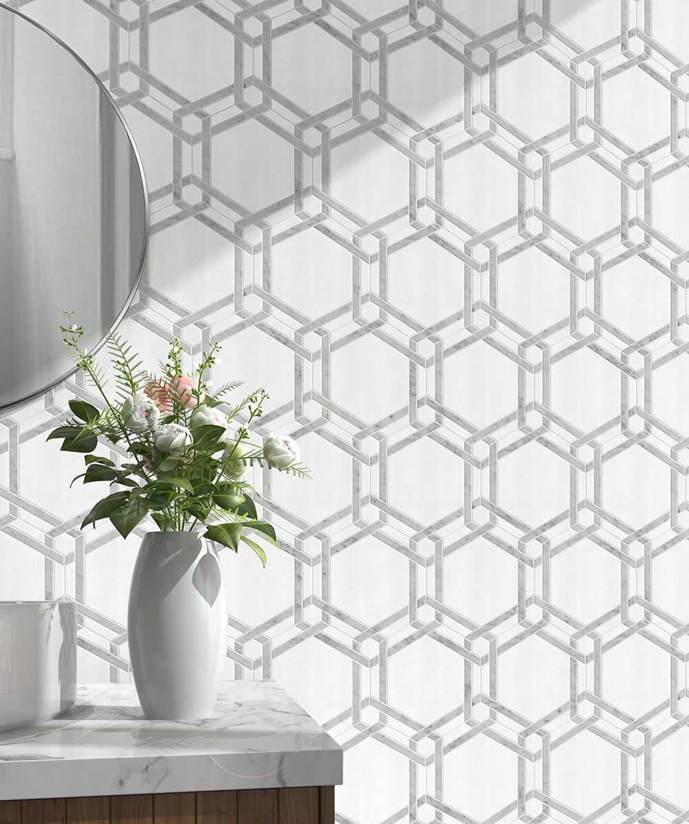 Bathroom with white patterned wallpaper, a round mirror, and a vase of flowers.