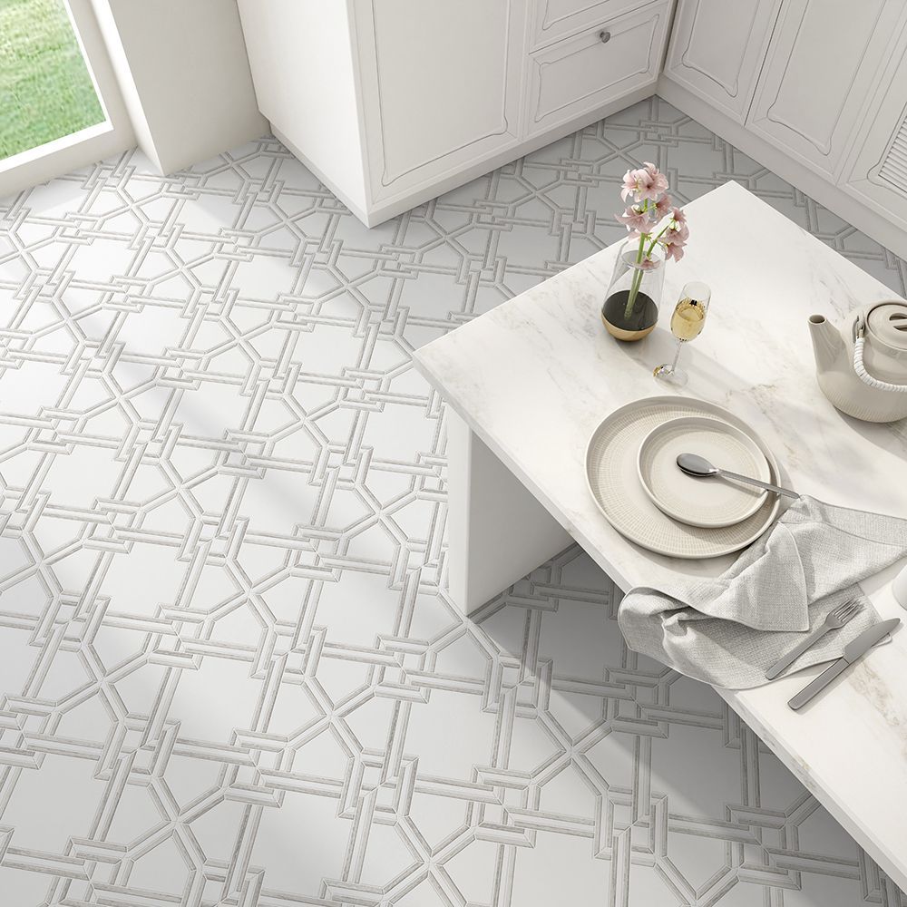 White kitchen with patterned tile floor, a table set for one, and cabinetry.
